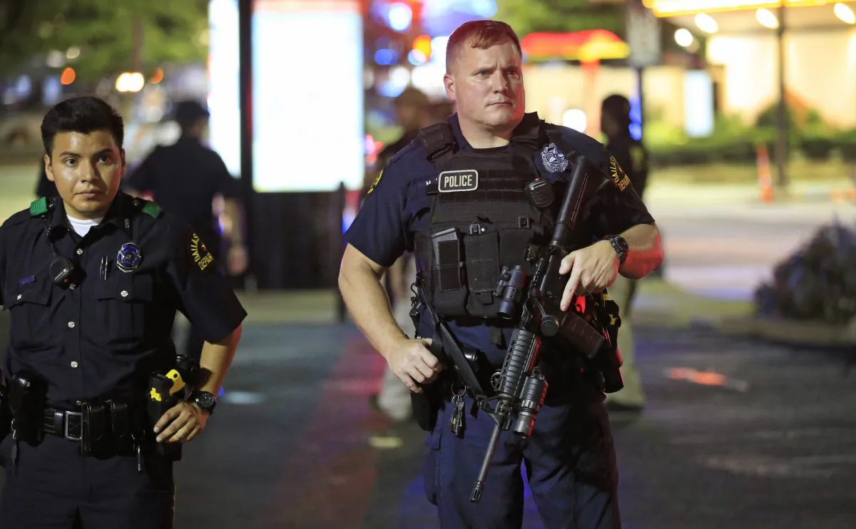 Dallas police stand near the scene where four Dallas police officers were shot and killed in Dallas, Texas, on July 2016. (Ron Jenkins/Getty Images)