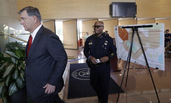 Dallas mayor Mike Rawlings, left, and Dallas police chief David Brown, right, leave a news conference, Friday, July 8, 2016, in Dallas. Snipers opened fire on police officers in the heart of Dallas Thursday night, during protests over two recent fatal police shootings of black men. (AP Photo/Eric Gay)