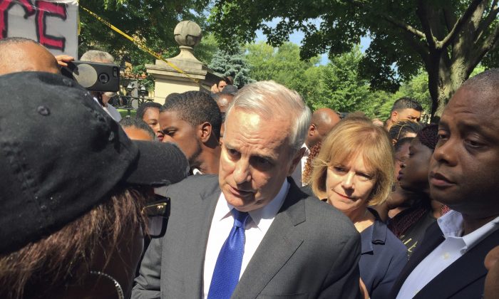 Minnesota Gov. Mark Dayton expresses his condolences to Diamond Reynolds for the death of her boyfriend, Philando Castile, outside the governor's residence Thursday, July 7, 2016, in St. Paul, Minn. Castile was shot and killed by Falcon Heights police on Wednesday night. (AP Photo/Kyle Potter)