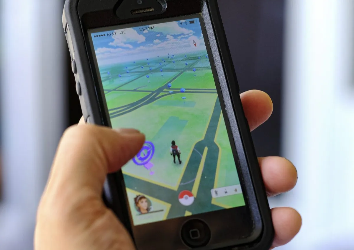 Pokemon Go is displayed on a cell phone in Los Angeles on Friday, July 8, 2016. Just days after being made available in the U.S., the mobile game Pokemon Go has jumped to become the top-grossing app in the App Store. (AP Photo/Richard Vogel)