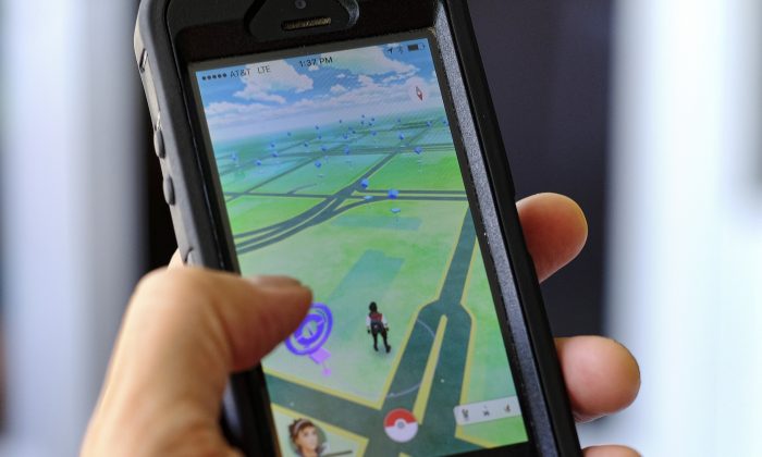 Pokemon Go is displayed on a cell phone in Los Angeles on Friday, July 8, 2016. Just days after being made available in the U.S., the mobile game Pokemon Go has jumped to become the top-grossing app in the App Store. (AP Photo/Richard Vogel)