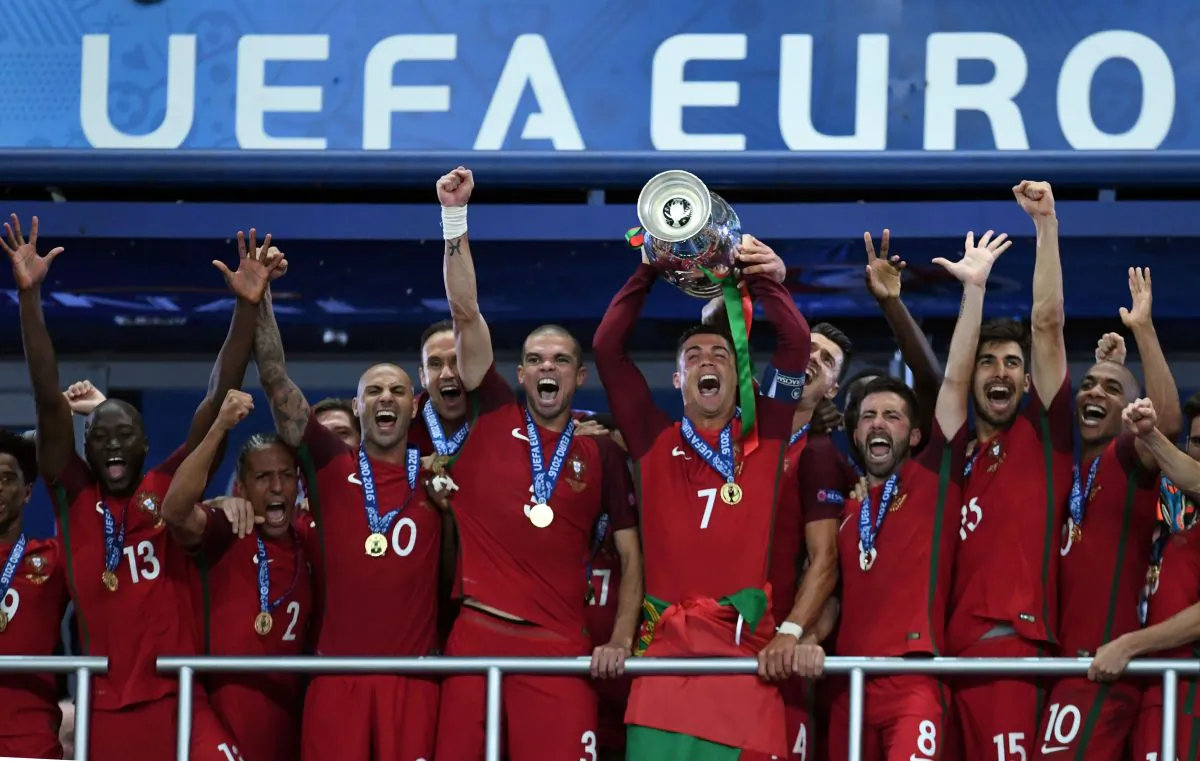 Cristiano Ronaldo lifts the Henri Delaunay Cup as he celebrates with his Portuguese teammates after they won the EURO 2016 final against France at the Stade de France in Saint-Denis on July 10, 2016. (Francisco Leong/AFP/Getty Images)