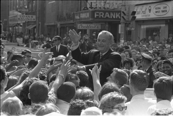 President Lyndon B. Johnson shakes hands with a crowd of supporters on June 30, 1966. (Public Domain)