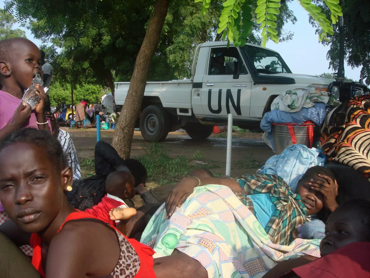 At least 3000 displaced women, men and children gather to seek shelter in Juba, South Sudan at the UN compound in Tomping area, Monday, July 11, 2016. Heavy explosions are shaking South Sudan's capital Juba Monday morning as clashes between government and opposition forces entered their fifth day, witnesses say, pushing the country back toward civil war. (Beatrice Mategwa/UNMISS via AP)