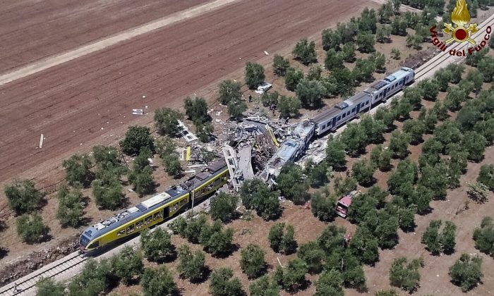 This aerial handout photo shows what is left of two commuters trains after their head-on collision in the southern region of Puglia, Tuesday, July 12, 2016. At least 10 people died and several others are reported injured. (Italian Firefighter Press Office via AP)