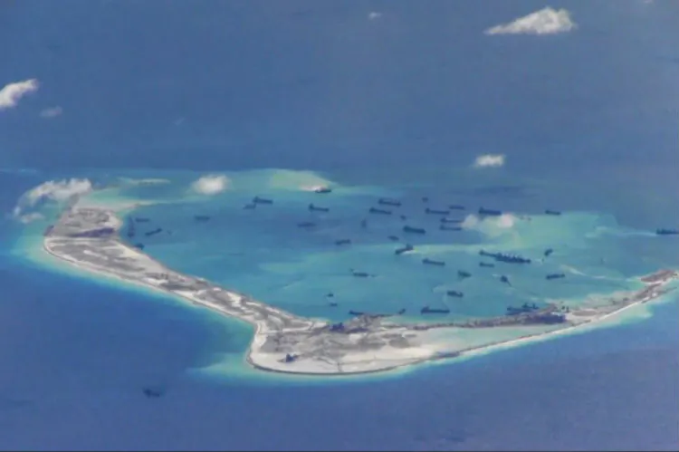 Chinese dredgers work on the construction of artificial islands on and around Mischief Reef in the Spratly Islands of the South China Sea on May 2, 2015. The U.S. Navy recently sent a warship to patrol near the Chinese regime’s man-made islands. (U.S. Navy)
