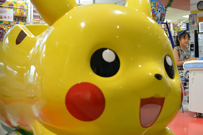 A Japanese girl plays at a Pokemon series character Pikachu-designed vehicle in Tokyo, Japan, July 12, 2016. New mobile game Pokemon Go has become an overnight sensation with U.S. (Photo by Hitoshi Yamada/NurPhoto via Getty Images)