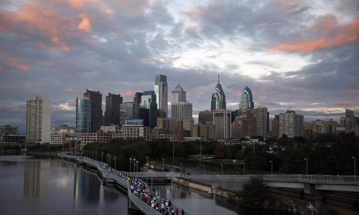 FILE - In this Oct. 1, 2014 file photo, runners jog along the Schuylkill Banks Boardwalk in Philadelphia. Democrats are set to begin their convention at the end of July 2016 in a city that symbolizes both the nation's promise and its shortcomings. (AP Photo/Matt Slocum, File)