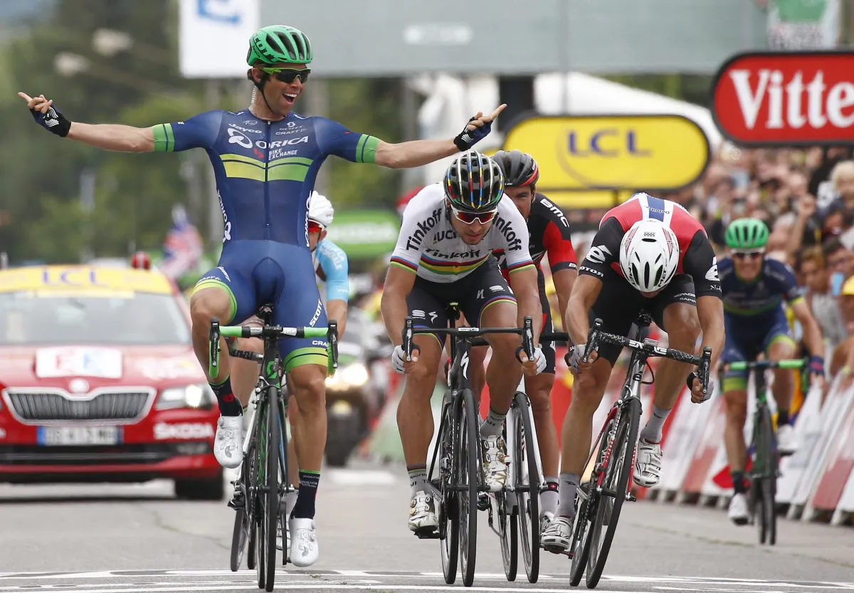Orica’s Michael Matthews, left, celebrates as he crosses the finish line head of Peter Sagan of Tinkoff, center, and Dimension Data’s Edvald Boasson Hagen to win Stage Ten of the 2016 Tour de France, 197 kilometers (122.4 miles) from Escaldes-Engordany, Andorra, to Revel, France, Tuesday, July 12, 2016. (AP Photo/Peter Dejong)