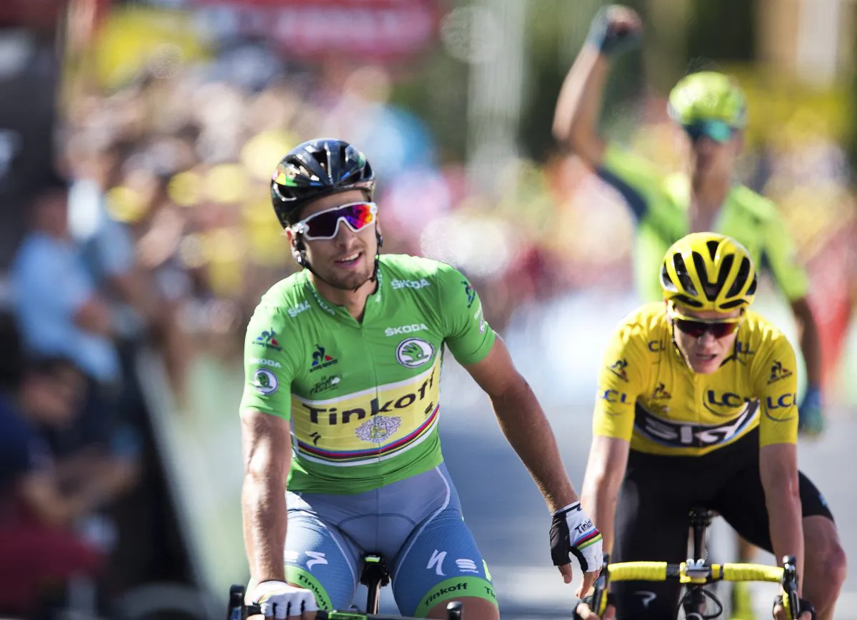 Tinkoff’s Peter Sagan crosses the finish line ahead of Sky's Chris Froome, while Tinkoff’s Maciej Bodnar, rear, fist-pumps at the end of Stage 11 of the 2016 Tour de Franc, 162.5 kilometers (100.7 miles) from Carcassonne to Montpellier, France, Wednesday, July 13, 2016.