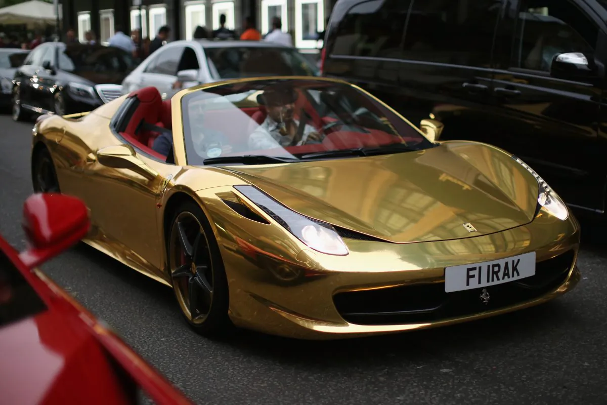 LONDON, ENGLAND - AUGUST 08:  A Gold Ferrari Drives through Knightsbridge on August 8, 2014 in London, England. Tourists and car enthusiasts have been flocking to the wealthy London district to see some of the world's most expensive and extravagant super cars. Many of the rich owners from Saudi Arabia and Kuwait come to London to escape the summer heat at home and to show off their cars before moving on to other European cities such as Paris and Cannes.  (Photo by Dan Kitwood/Getty Images)