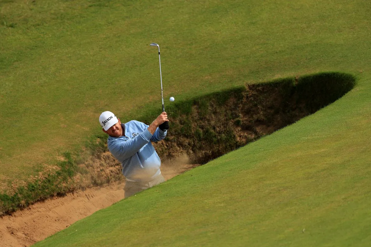 JB Holmes of the United States hits a bunker shot on the 8th during a practice round ahead of the 145th Open Championship at Royal Troon on July 12 in Troon, Scotland. (Mike Ehrmann/Getty Images)
