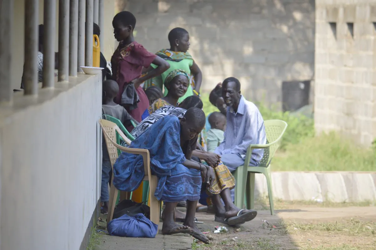 In this Tuesday July 12, 2016 photo, people take shelter near the All Saints Church in Juba, South Sudan. Embassies and aid organizations in South Sudan were trying to evacuate staff from the capital, Juba, on Tuesday as a precarious calm settled over the city following several days of deadly clashes. (AP Photo)