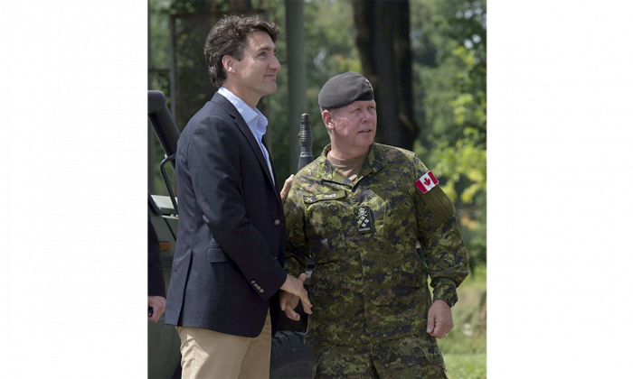 Prime Minister Justin Trudeau meets with Chief of Defence Staff Jonathan Vance before watching a live fire exercise at the International Peacekeeping and Security Centre near Yavoriv, Ukraine, on July 12, 2016. (The Canadian Press/Adrian Wyld)