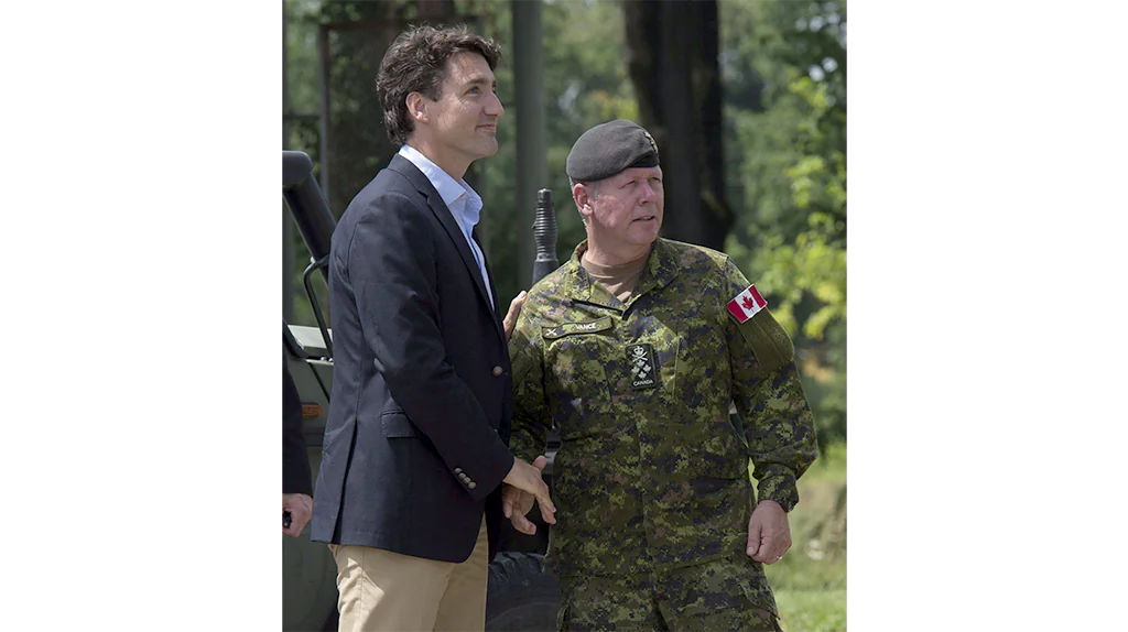 Prime Minister Justin Trudeau meets with Chief of Defence Staff Jonathan Vance before watching a live fire exercise at the International Peacekeeping and Security Centre near Yavoriv, Ukraine, on July 12, 2016. (The Canadian Press/Adrian Wyld)