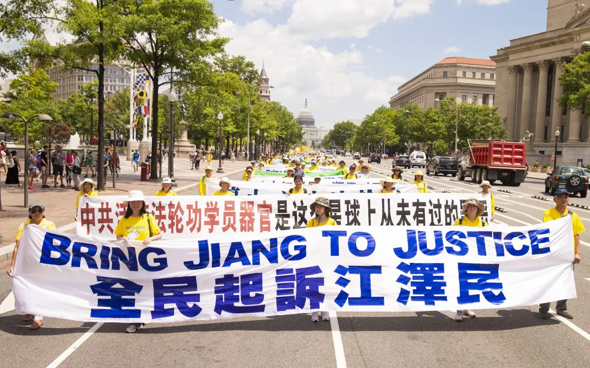Falun Gong practitioners march in Washington on July 14, 2016, calling for Jiang Zemin, the former dictator who instigated the persecution of Falun Gong in China, to be brought to justice. (Larry Dye/The Epoch Times)