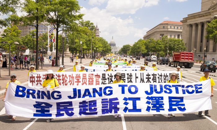 Falun Gong practitioners march in Washington on July 14, 2016, calling for Jiang Zemin, the former dictator who instigated the persecution of Falun Gong in China, to be brought to justice. (Larry Dye/The Epoch Times)