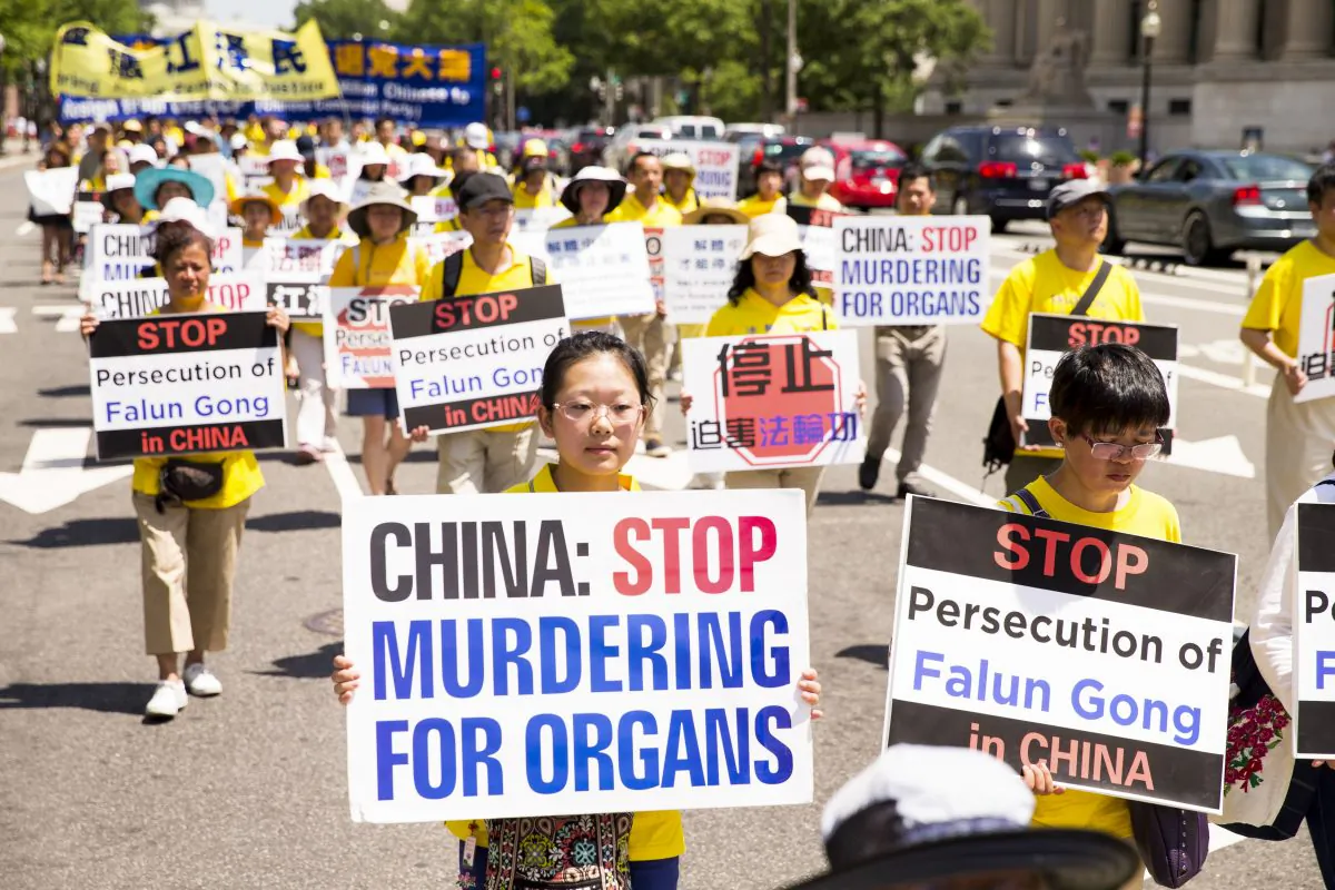Falun Gong practitioners hold a march in Washington on July 14, calling for Jiang Zemin, the former dictator who instigated the persecution of Falun Gong in China, to be brought to justice. (Larry Dye/Epoch Times)
