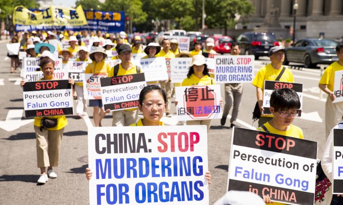 Falun Gong practitioners hold a march in Washington on July 14, calling for Jiang Zemin, the former dictator who instigated the persecution of Falun Gong in China, to be brought to justice. (Larry Dye/Epoch Times)