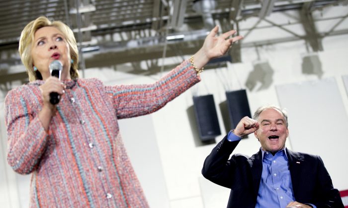 Democratic presidential candidate Hillary Clinton, accompanied by Sen. Tim Kaine, D-Va., right, speaks at a rally at Northern Virginia Community College in Annandale, Thursday, July 14, 2016.  (AP Photo/Andrew Harnik)