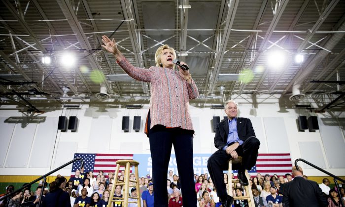 Democratic presidential candidate Hillary Clinton, accompanied by Sen. Tim Kaine, D-Va., right, speaks at a rally at Northern Virginia Community College in Annandale, Thursday, July 14, 2016. Kaine has been rumored to be one of Clinton's possible vice president choices. (AP Photo/Andrew Harnik)