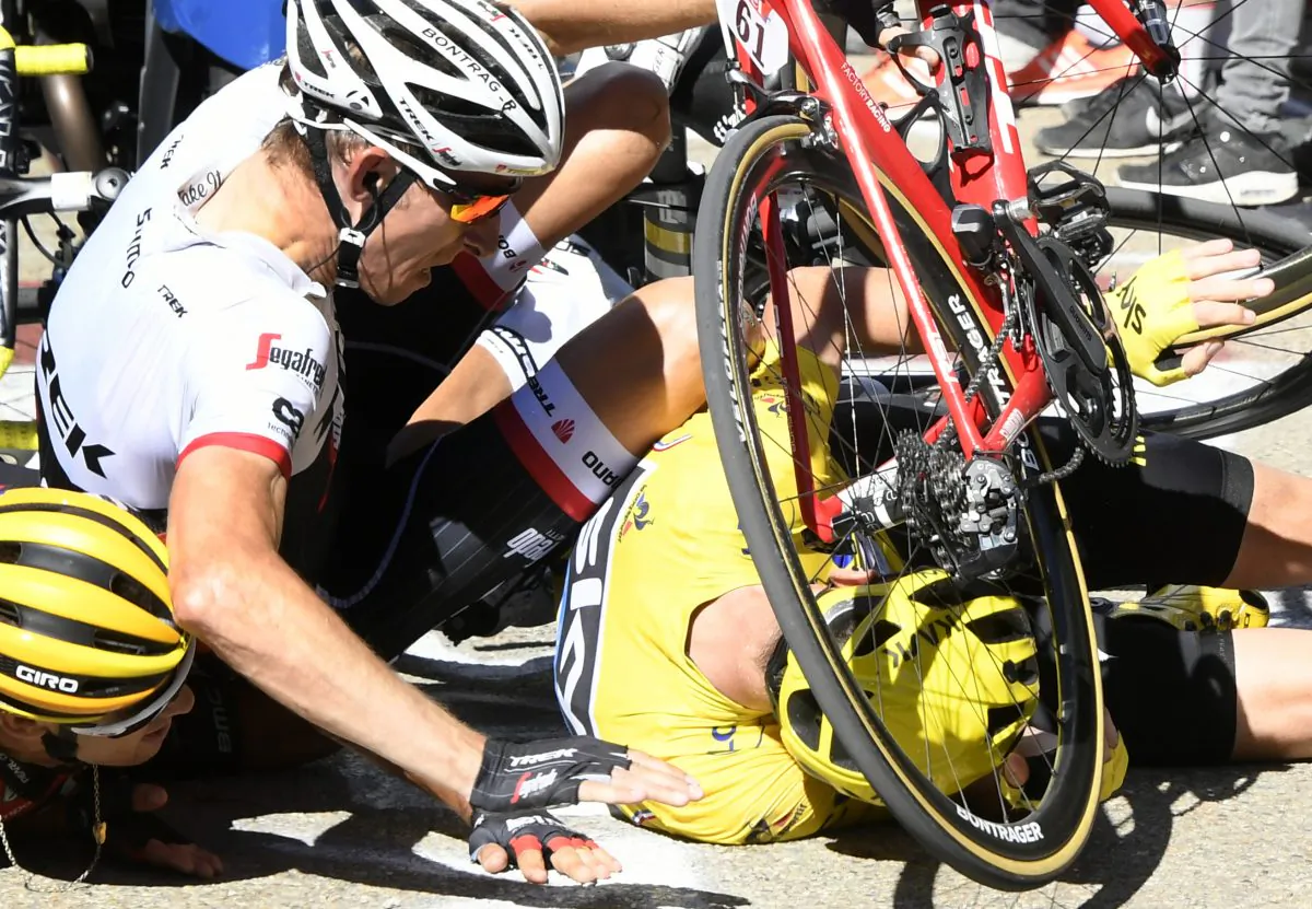 Richie Porte, Chris Froome, and Bauke Mollema fight their way through the crowd in the final kilometer of Stage 12 of the 2016 Tour de France, seconds before the trio crashed headlong into a TV motorcycle. (AP Photo/Peter Dejong)

Sky's Chris Froome, wearing the overall leader's yellow jersey, right, Trek-Segafredo’s Bauke Mollema, center, and BMC’s Richie Porte crash at the end of Stage 12 of the Tour de France, Thursday, July 14, 2016.  (Bernard Papon/ Pool Photo via AP)