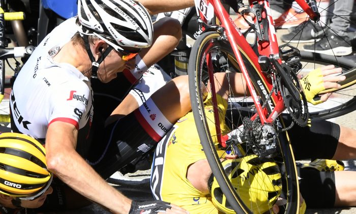 Richie Porte, Chris Froome, and Bauke Mollema fight their way through the crowd in the final kilometer of Stage 12 of the 2016 Tour de France, seconds before the trio crashed headlong into a TV motorcycle. (AP Photo/Peter Dejong)

Sky's Chris Froome, wearing the overall leader's yellow jersey, right, Trek-Segafredo’s Bauke Mollema, center, and BMC’s Richie Porte crash at the end of Stage 12 of the Tour de France, Thursday, July 14, 2016.  (Bernard Papon/ Pool Photo via AP)