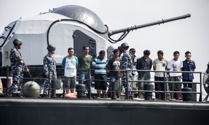Indonesian navy soldiers display nine piracy suspects in Surabaya, East Java province, on May 10, 2016. (Juni Kriswanto/AFP/Getty Images)