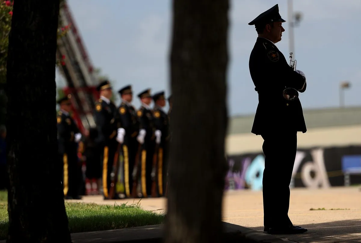 Honor guard stands at attention as the casket of slain Dallas Area Rapid Transit (DART) police officer Brent Thompson is prepared to be loaded into a hearse during a funeral service at the Potter's House Church on July 13, 2016 in Dallas, Texas. (Justin Sullivan/Getty Images)