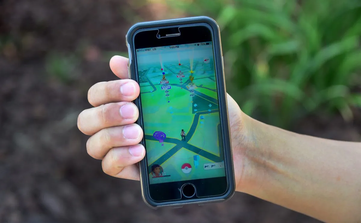 Eric Lee displays the game Pokemon Go on his cellphone on July 13, 2016 in San Gabriel, California where he and friends were playing at the San Gabriel Mission, one of a number of landmarks across communities in southern California which can serve as gathering point for people playing the game. (Frederic J. Brown/AFP/Getty Images)