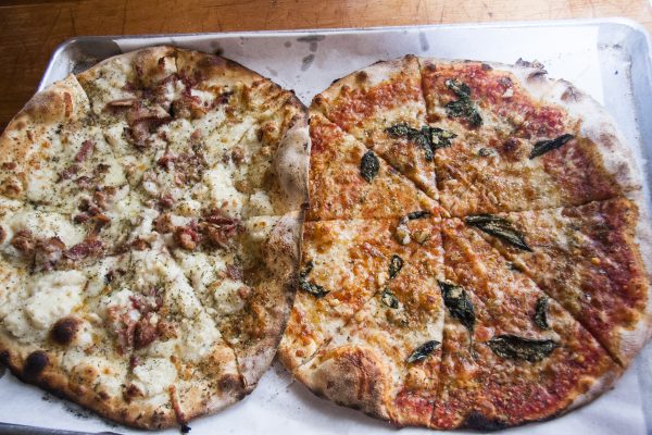 Mashed potato and bacon pie (L) and mozzarella, tomato, and basil pie at Bar, a new-school pizza joint and bar. (Annie Wu/Epoch Times)