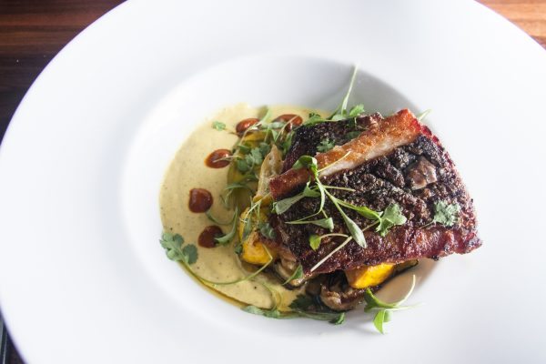 Pan-Seared Striped Bass with a creamy, spicy corn-oregano purée at farm-to-table restaurant Heirloom. (Annie Wu/Epoch Times)