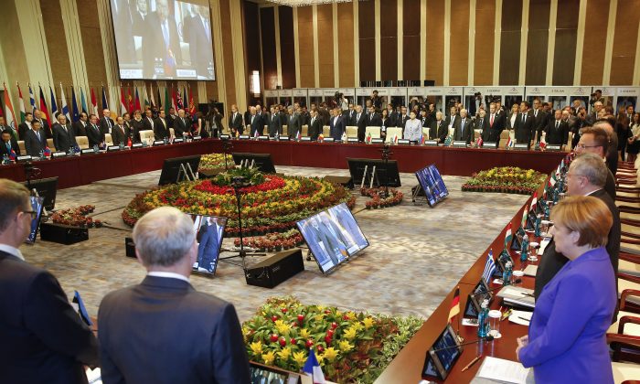 Leaders stand for a minute of silence for the victims of a deadly attack in the French city of Nice, before the opening session of the Asia-Europe Meeting (ASEM) summit in Ulaanbaatar, Mongolia, Friday, July 15, 2016. (Damir Sagolj/Pool Photo via AP)