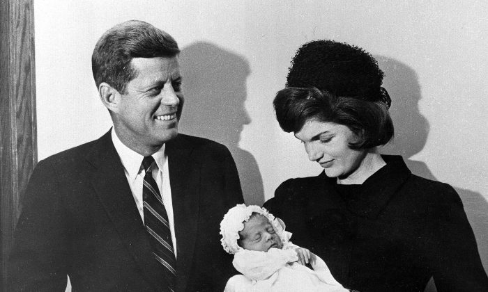 President-elect John F. Kennedy and Jacqueline Kennedy pose at Georgetown University Hospital in Washington with their son, John F. Kennedy Jr., following a baptism for the infant on Dec. 8, 1960. (AP Photo)