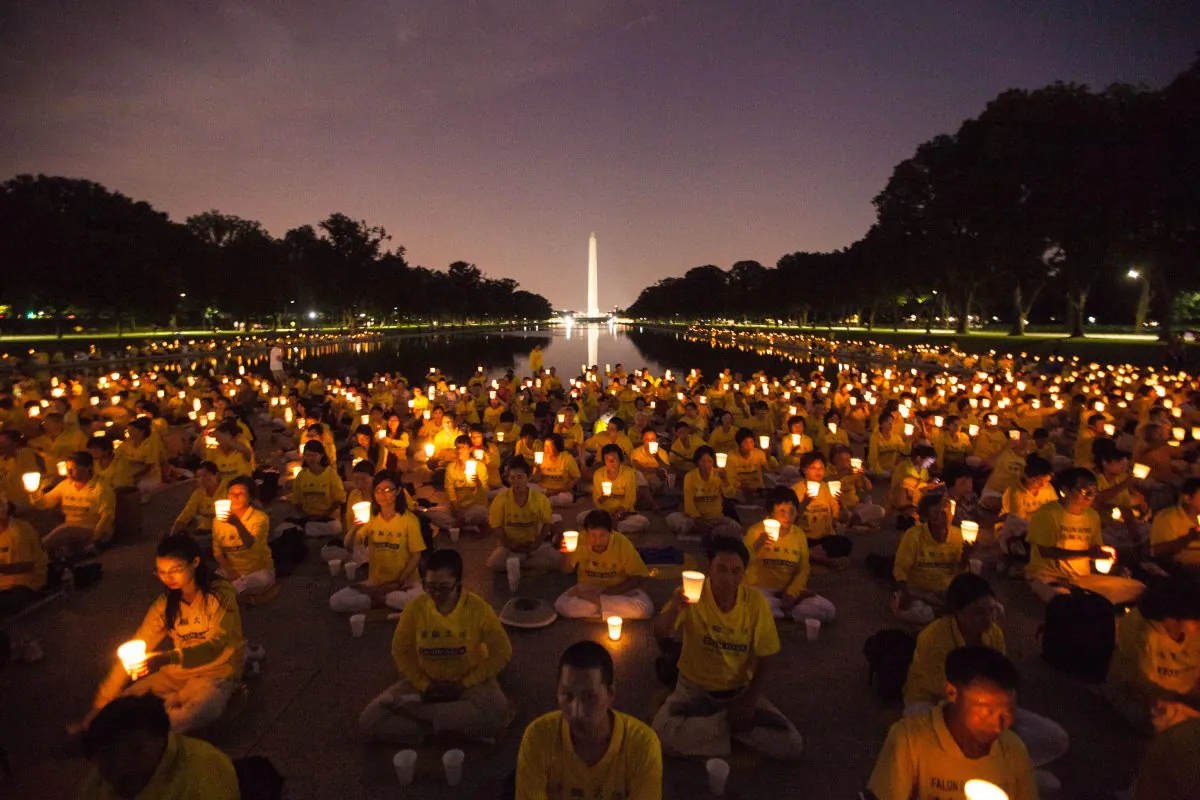 Falun Gong practitioners hold a candlelight vigil for those who have died during the persecution in China, in Washington, D.C., on July 14, 2016. This years marks the 17th year of the persecution inside China. (Benjamin Chasteen/Epoch Times)
