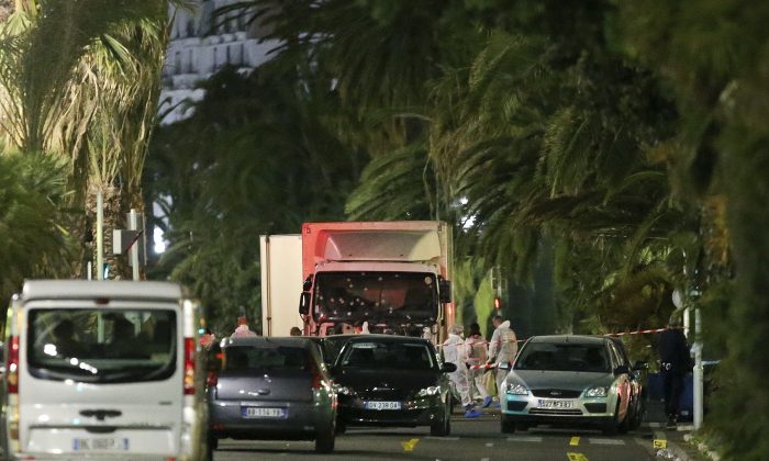 The truck which slammed into revelers late Thursday, July 14, is seen near the site of an attack in the French resort city of Nice, southern France, Friday, July 15, 2016. The truck loaded with weapons and hand grenades drove onto a sidewalk for more than a mile, plowing through Bastille Day revelers who'd gathered to watch fireworks in the French resort city of Nice late Thursday.  (AP Photo/Luca Bruno)