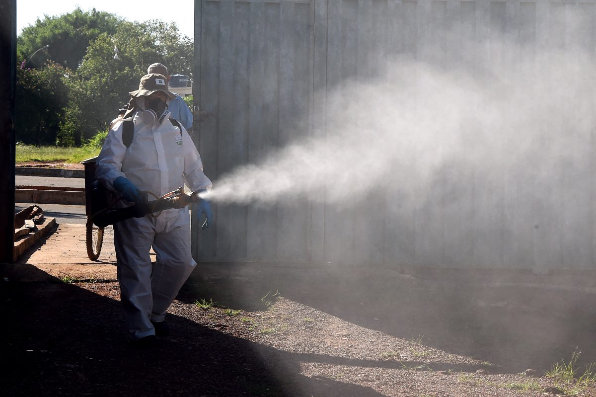 A employee of Brazil's National Health Foundation fumigates against the Aedes aegypti mosquito, vector of the Dengue, Chikungunya fever and Zika viruses, in Gama, 28 miles south of Brasilia, on Feb. 17, 2016. (Evaristo Sa/AFP/Getty Images)