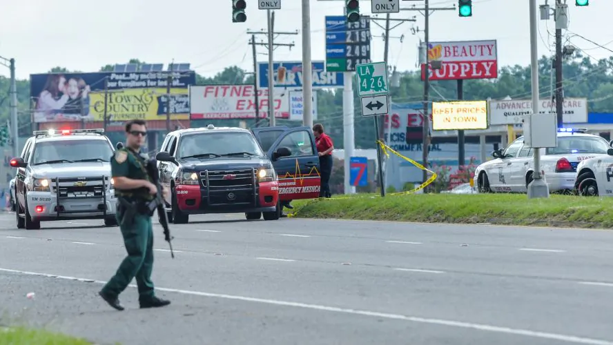 Baton Rouge police respond to active shooter near Hammond Aire Shopping Center in Baton Rouge, Sunday, July, 17, 2016. Multiple law enforcement officers were killed and wounded Sunday morning in a shooting near a gas station in Baton Rouge, less than two weeks after a black man was shot and killed by police here, sparking nightly protests across the city. (Scott Clause/The Daily Advertiser via AP)