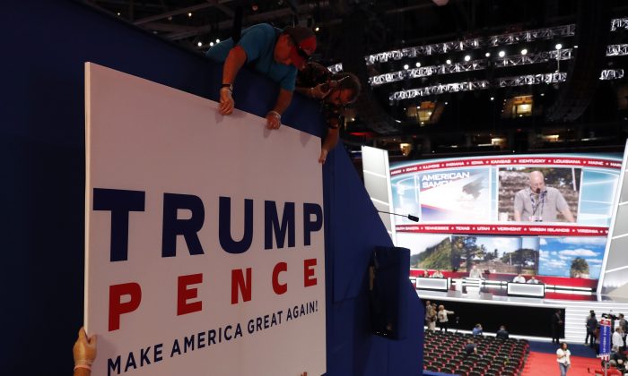 Workers place a sign as they prepare at Quicken Loans Arena for the Republican National Convention, Sunday, July 17, 2016, in Cleveland. (AP Photo/Carolyn Kaster)