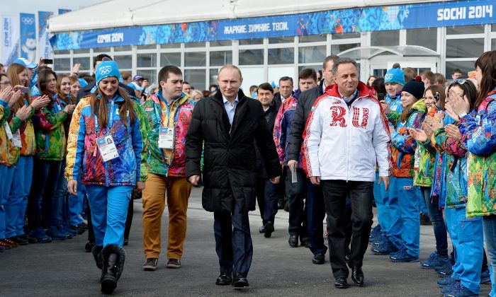 FILE - In this Feb. 5, 2014 file photo Russian President Vladimir Putin, center, visits the Olympic Athletes Village in Coastal Cluster ahead of the Sochi 2014 Winter Olympics with Olympic Village Mayor Elena Isinbaeva, left, and Russian Minister of Sport, Tourism and Youth policy Vitaly Mutko in Sochi, Russia. On Monday, July 18, 2016 WADA investigator Richard McLaren confirmed claims of state-run doping in Russia. (Pascal Le Segretain/Pool Photo via AP, file)
