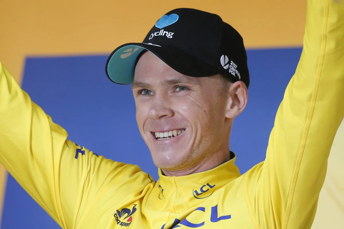 Chris Froome, wearing the overall leader's yellow jersey, celebrates on the podium after Stage Nine of the Tour de France on July 10, 2016. (Christophe Ena/AP Photo)
