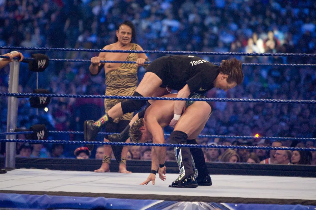 HOUSTON, TX - APRIL 5: (L-R) Former professional wrestlers Ricky "The Dragon" Steamboat (not pictured), Jimmy "Superfly" Snuka look on as "Rowdy" Roddy Piper battles WWE Superstar Chris Jericho during WrestleMania 25 at Reliant Stadium on April 5, 2009 in Houston, Texas. (Photo by Bill Olive/Getty Images)