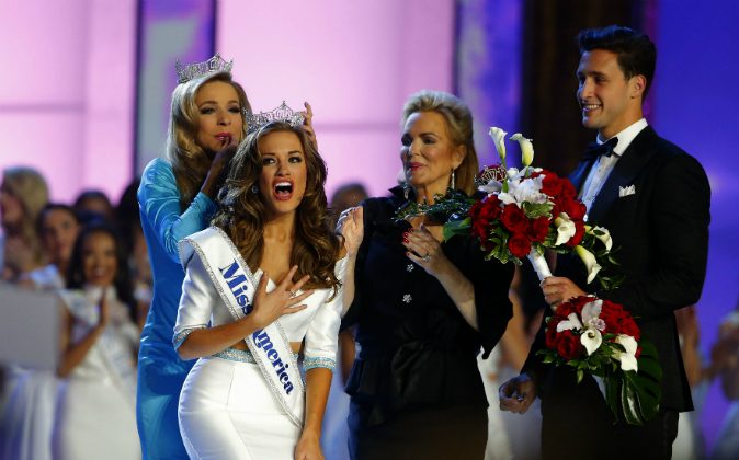 In this Sept. 13, 2015, file photo, Miss America 2015 Kira Kazantsev crowns Miss Georgia Betty Cantrell as Miss America 2016 in Atlantic City, N.J. (AP Photo/Noah K. Murray, File)