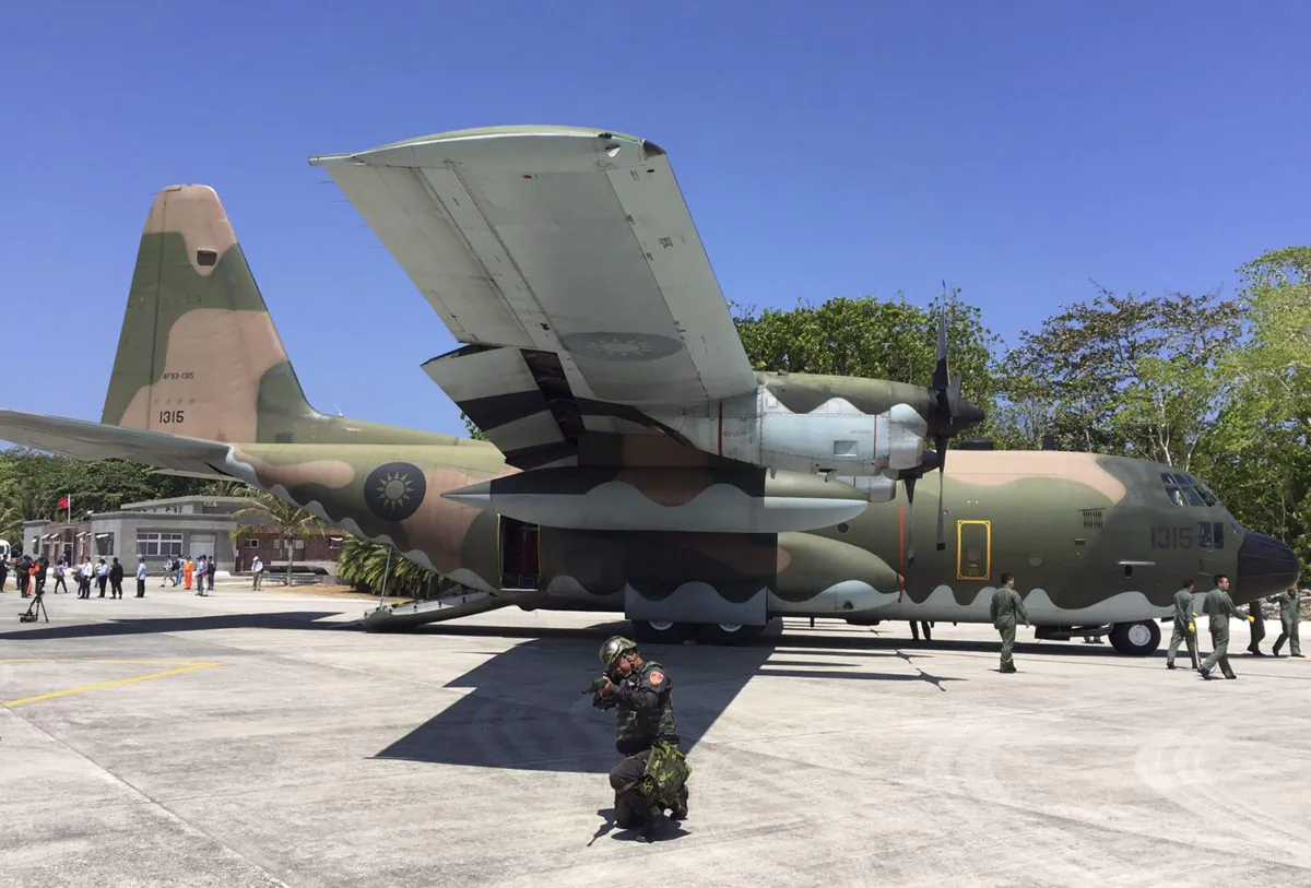 A military transport plane sits on the tarmac of Taiping Island on March 23, 2016, after Taiwan flew international media to the island in a bid to reinforce its territorial claims in the disputed and increasingly tense region. Adding to Taiwan’s concerns is the impact a July 12 ruling by The Hague will have on its sovereignty over Taiping Island. (AP Photo/Johnson Lai)