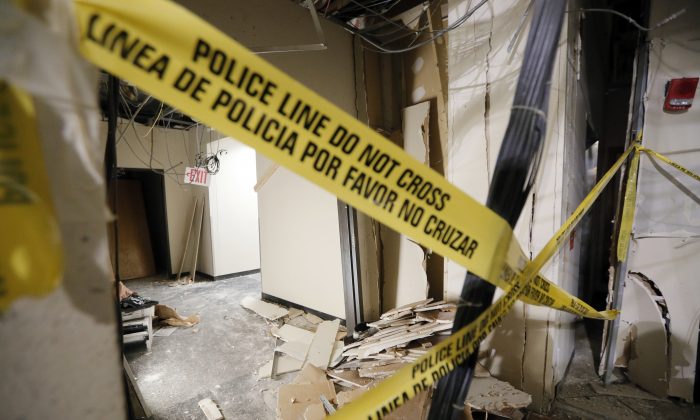 Damage from a blast is shown in a hallway at El Centro College downtown campus, Tuesday, July 19, 2016, in Dallas. According to officials, this is where gunman Micah Johnson was killed by the blast after he killed five police officers wounding several earlier this month during a protest. (AP Photo/Tony Gutierrez)