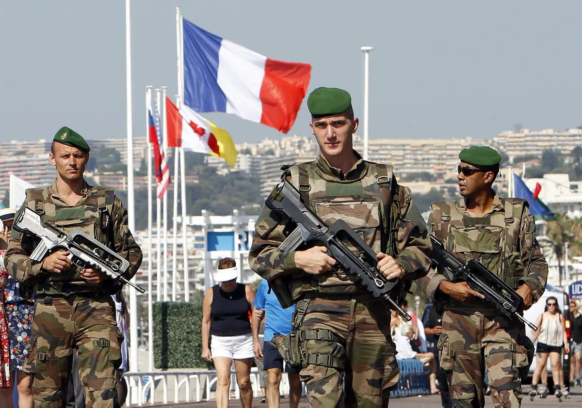 Soldiers patrols on the Promenade des Anglais in Nice, southern France, Tuesday, July 19, 2016. Joggers, cyclists and sun-seekers are back on Nice's famed Riviera coast, a further sign of normal life returning on the Promenade des Anglais where dozens were killed in last week's Bastille Day truck attack. (AP Photo/Claude Paris)