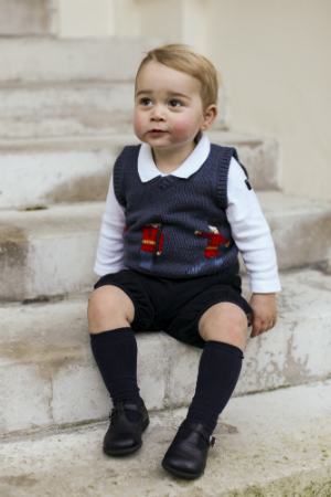 In this handout image of three released on December 13, 2014 by Kensington Palace, Prince George sits for his official Christmas picture in a courtyard at Kensington Palace in late November of 2014 in London, England. (The Duke and Duchess of Cambridge/PA Wire via Getty Images)