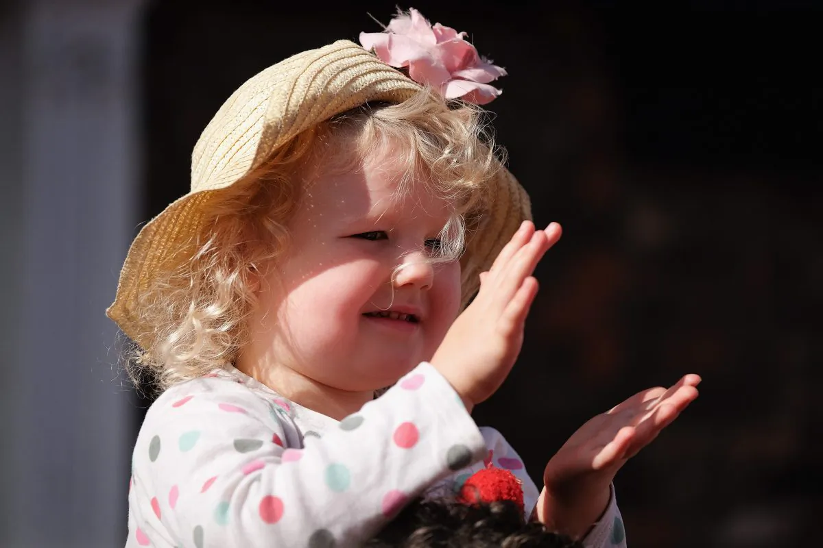 A young girl claps as she watches the colliery bands pass by during the annual Durham Miners Gala on July 11, 2015 in Durham, England. This is the 131st gala which brings together the communal values, culture and mining heritage of the north east of England. Thousands of people attend the event to listen to the brass bands, socialise and show their allegiance to the banners from the former colliery villages throughout the north.  (Photo by Ian Forsyth/Getty Images)