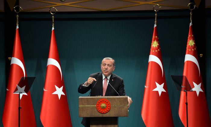Turkey's President Recep Tayyip Erdogan speaks after an emergency meeting of the government in Ankara, Turkey, late Wednesday, July 20, 2016. Erdogan on Wednesday declared a three-month state of emergency following a botched coup attempt, declaring he would rid the military of the "virus" of subversion and giving the government sweeping powers to expand a crackdown.(AP Photo)
