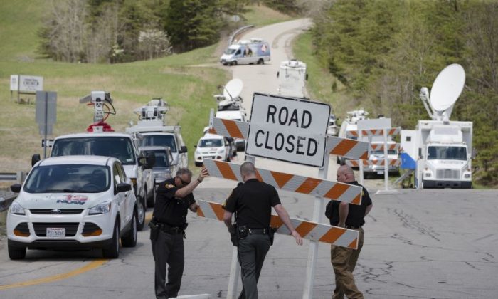 In this April 22, 2016, file photo, authorities set up roadblocks at the perimeter of one of four properties near Piketon, Ohio, where seven adults and a 16-year-old boy from the Rhoden family were found shot to death.  (AP Photo/John Minchillo, File)
